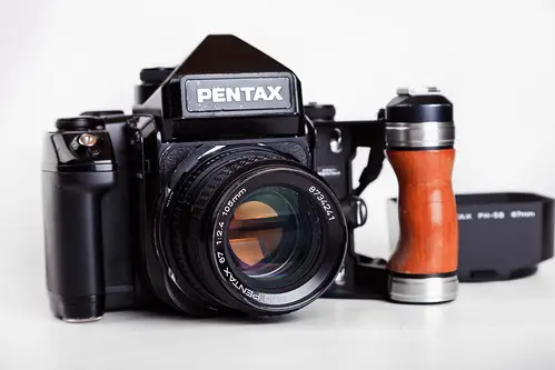 Pentax 67 II body w/- wooden grip + original strap + 105mm f/2.4 Grade 9